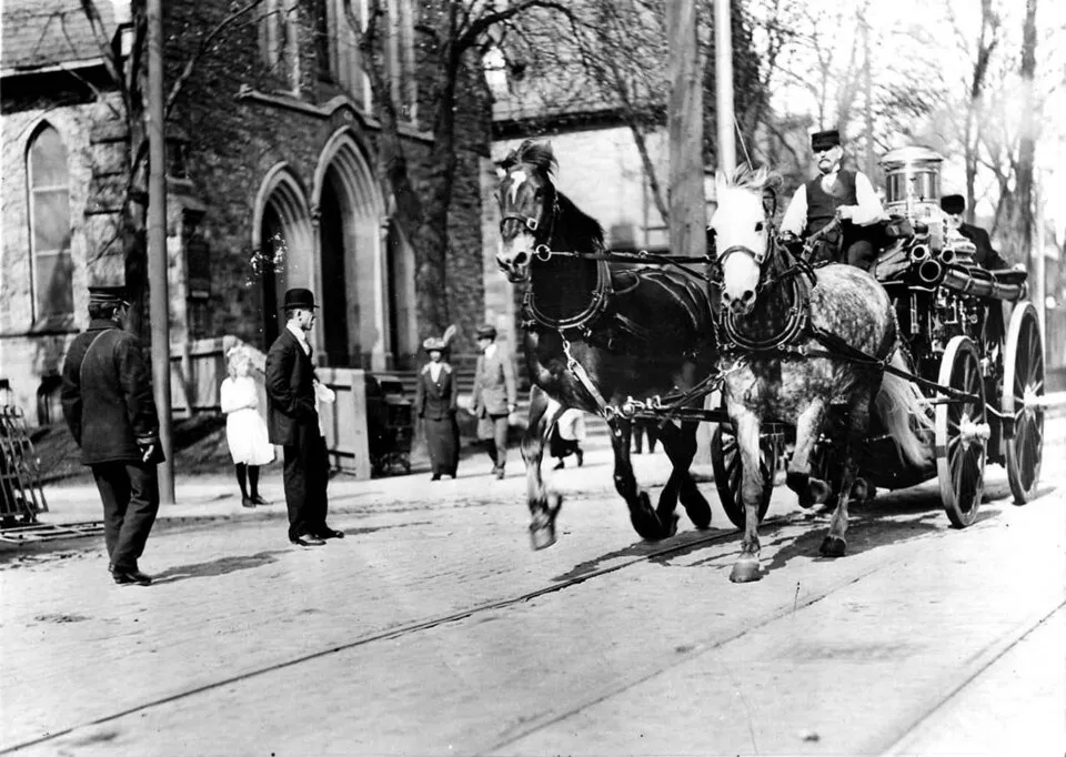 Horse-drawn fire wagon moving along Bloor Street in Toronto